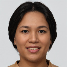 Joyful asian young-adult female with medium  brown hair and brown eyes