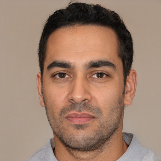 Neutral latino young-adult male with short  black hair and brown eyes