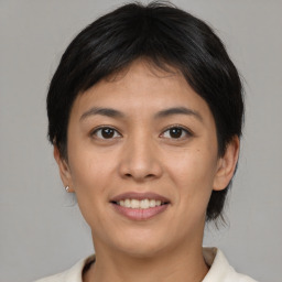 Joyful asian young-adult female with short  brown hair and brown eyes