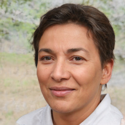 Joyful white adult female with short  brown hair and brown eyes