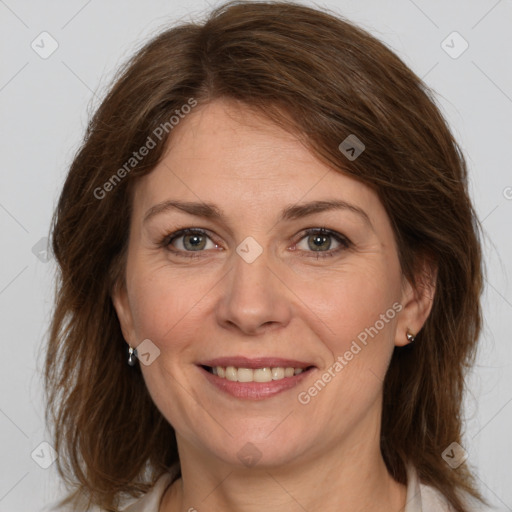 Joyful white adult female with medium  brown hair and grey eyes