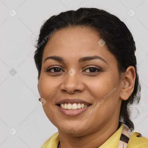 Joyful latino young-adult female with medium  brown hair and brown eyes