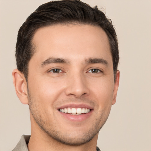 Joyful white young-adult male with short  brown hair and brown eyes