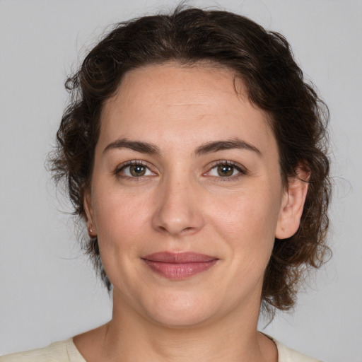 Joyful white adult female with medium  brown hair and brown eyes