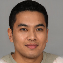 Joyful latino young-adult male with short  brown hair and brown eyes