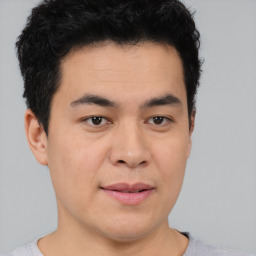 Joyful asian young-adult male with short  black hair and brown eyes