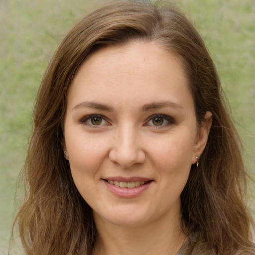 Joyful white young-adult female with long  brown hair and green eyes