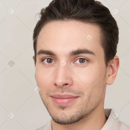 Joyful white young-adult male with short  brown hair and brown eyes