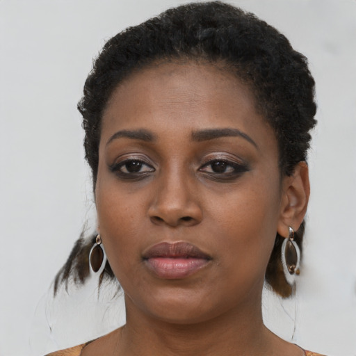 Neutral black young-adult female with medium  brown hair and brown eyes