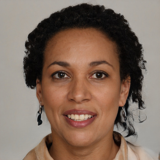 Joyful black adult female with short  brown hair and brown eyes