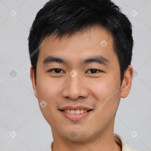 Joyful asian young-adult male with short  black hair and brown eyes