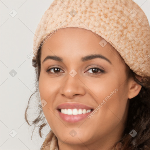 Joyful latino young-adult female with long  brown hair and brown eyes