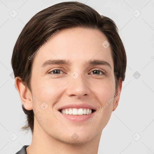 Joyful white young-adult male with short  brown hair and grey eyes