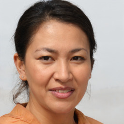 Joyful white adult female with medium  brown hair and brown eyes