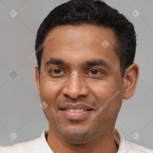 Joyful latino adult male with short  black hair and brown eyes