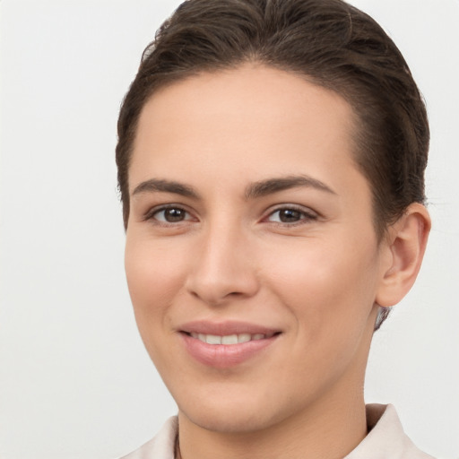 Joyful white young-adult female with short  brown hair and brown eyes