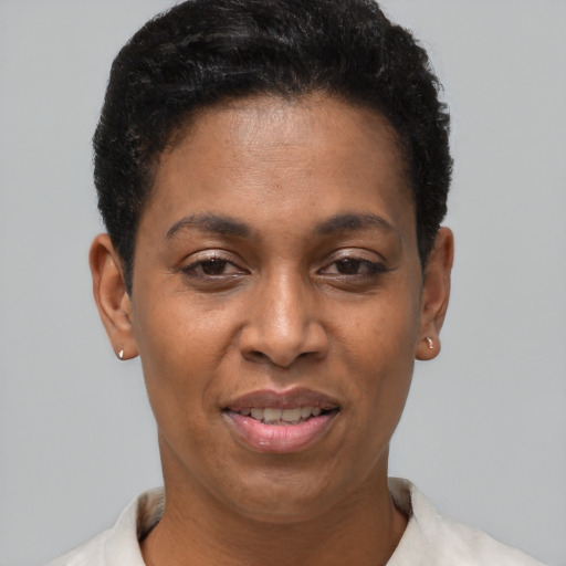 Joyful black adult female with short  black hair and brown eyes