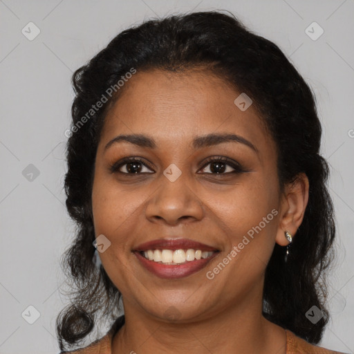 Joyful black young-adult female with long  brown hair and brown eyes