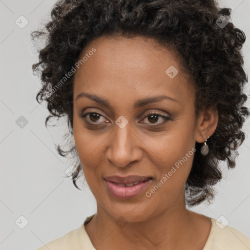 Joyful black adult female with medium  brown hair and brown eyes