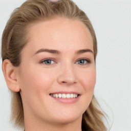 Joyful white young-adult female with long  brown hair and blue eyes