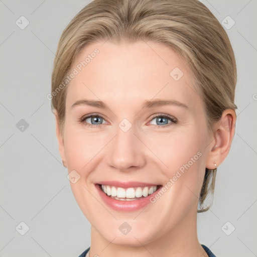 Joyful white young-adult female with medium  brown hair and blue eyes