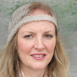 Joyful white adult female with long  brown hair and grey eyes