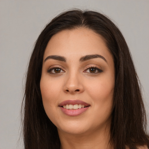 Joyful white young-adult female with long  brown hair and brown eyes