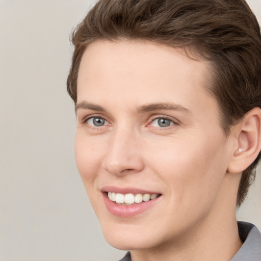 Joyful white young-adult female with short  brown hair and grey eyes