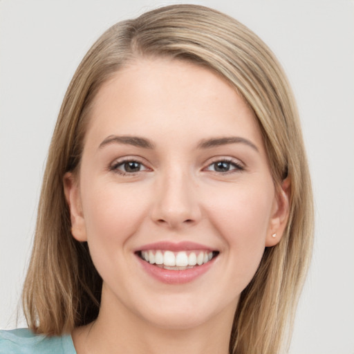 Joyful white young-adult female with long  brown hair and grey eyes