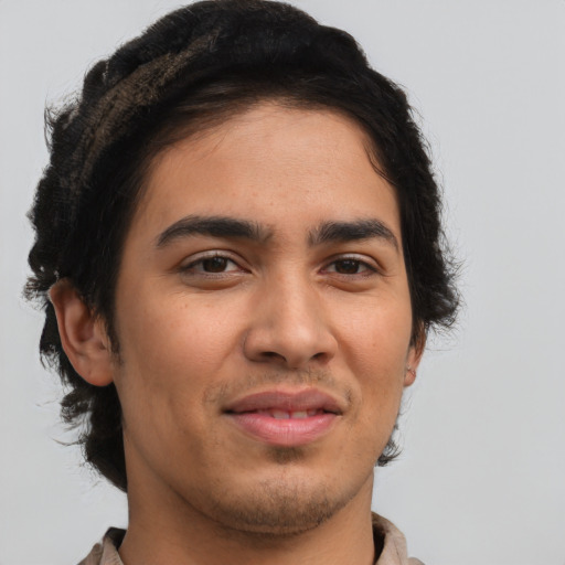 Joyful latino young-adult male with short  brown hair and brown eyes