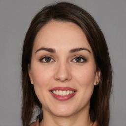 Joyful white young-adult female with medium  brown hair and brown eyes