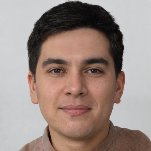 Joyful white young-adult male with short  black hair and brown eyes