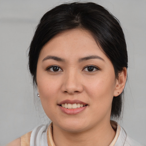 Joyful asian young-adult female with medium  brown hair and brown eyes