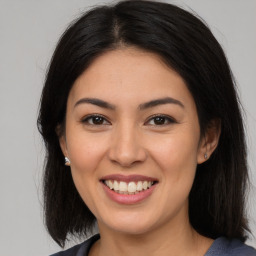 Joyful asian young-adult female with long  brown hair and brown eyes