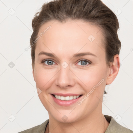 Joyful white young-adult female with short  brown hair and grey eyes