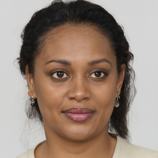 Joyful black young-adult female with medium  brown hair and brown eyes