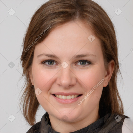 Joyful white young-adult female with medium  brown hair and grey eyes