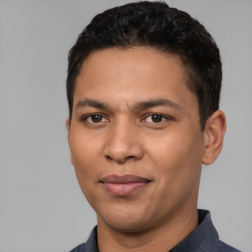 Joyful latino young-adult male with short  black hair and brown eyes