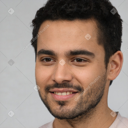 Joyful white young-adult male with short  black hair and brown eyes