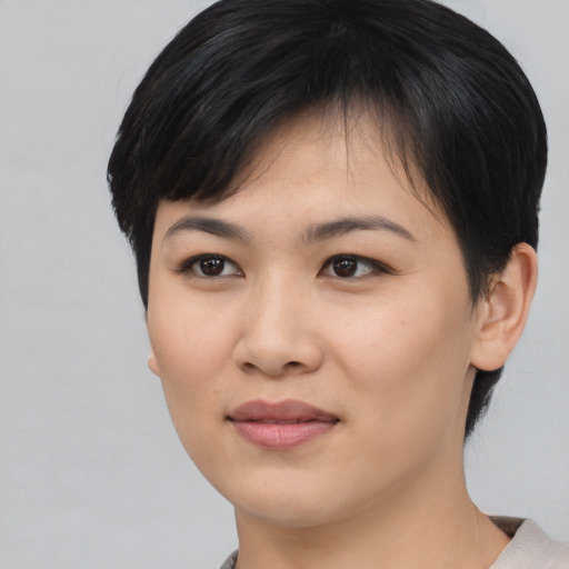 Joyful asian young-adult female with medium  black hair and brown eyes
