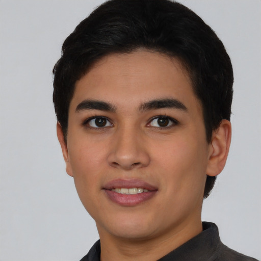 Joyful latino young-adult male with short  black hair and brown eyes