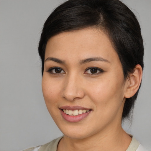 Joyful asian young-adult female with medium  brown hair and brown eyes