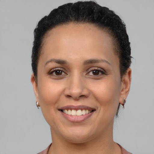 Joyful black young-adult female with short  brown hair and brown eyes