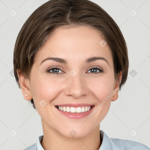 Joyful white young-adult female with short  brown hair and grey eyes