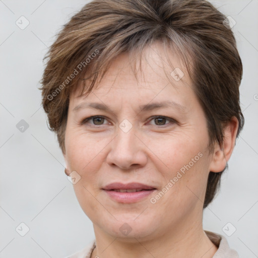 Joyful white adult female with short  brown hair and grey eyes