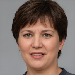 Joyful white adult female with short  brown hair and grey eyes