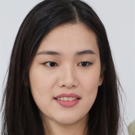 Joyful asian young-adult female with long  brown hair and brown eyes