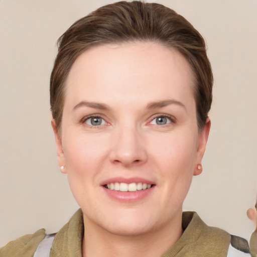 Joyful white young-adult female with short  brown hair and grey eyes