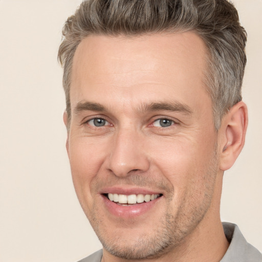 Joyful white adult male with short  brown hair and brown eyes