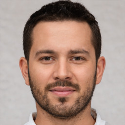 Joyful white young-adult male with short  brown hair and brown eyes